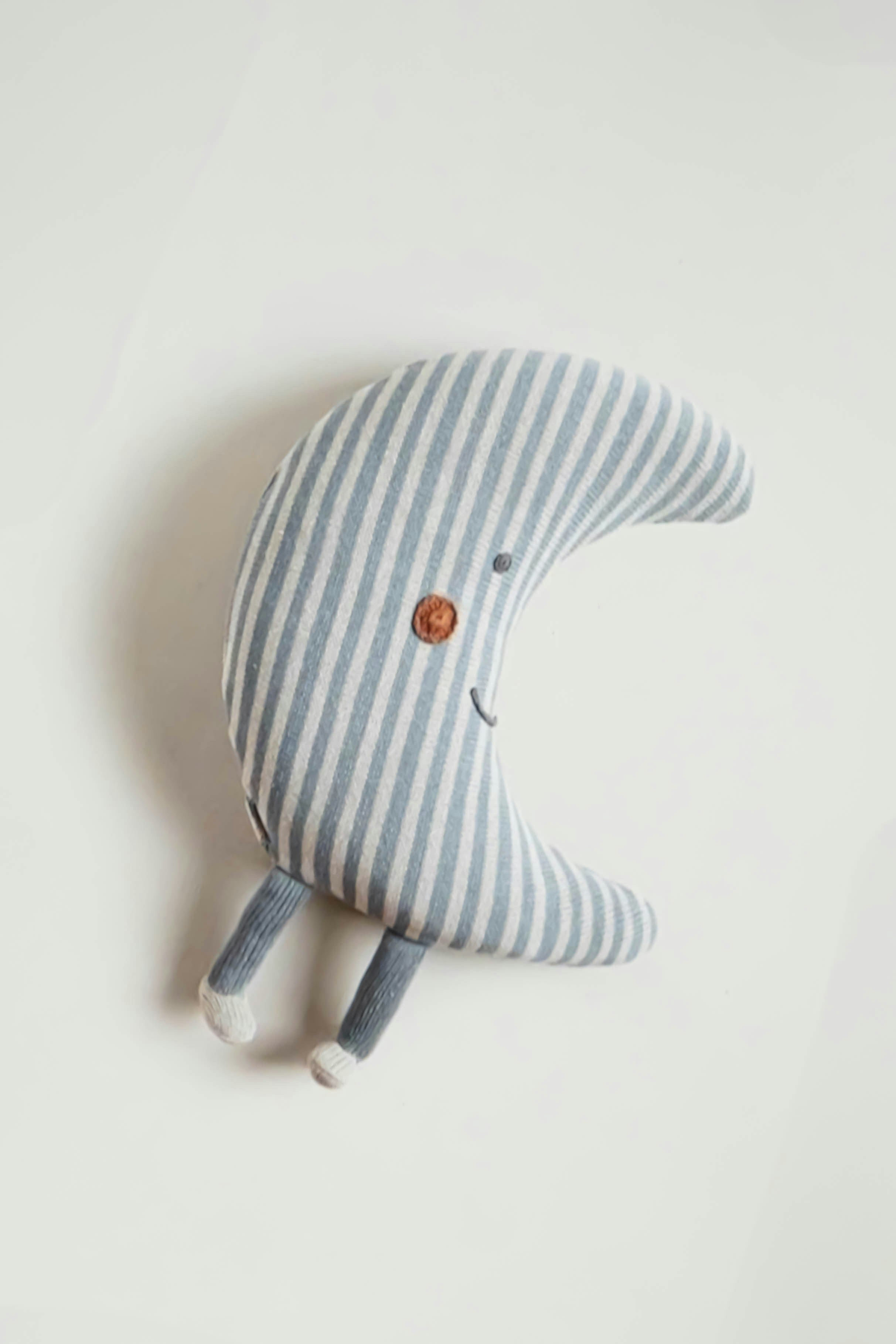 Plush crescent moon toy with blue and white stripes
