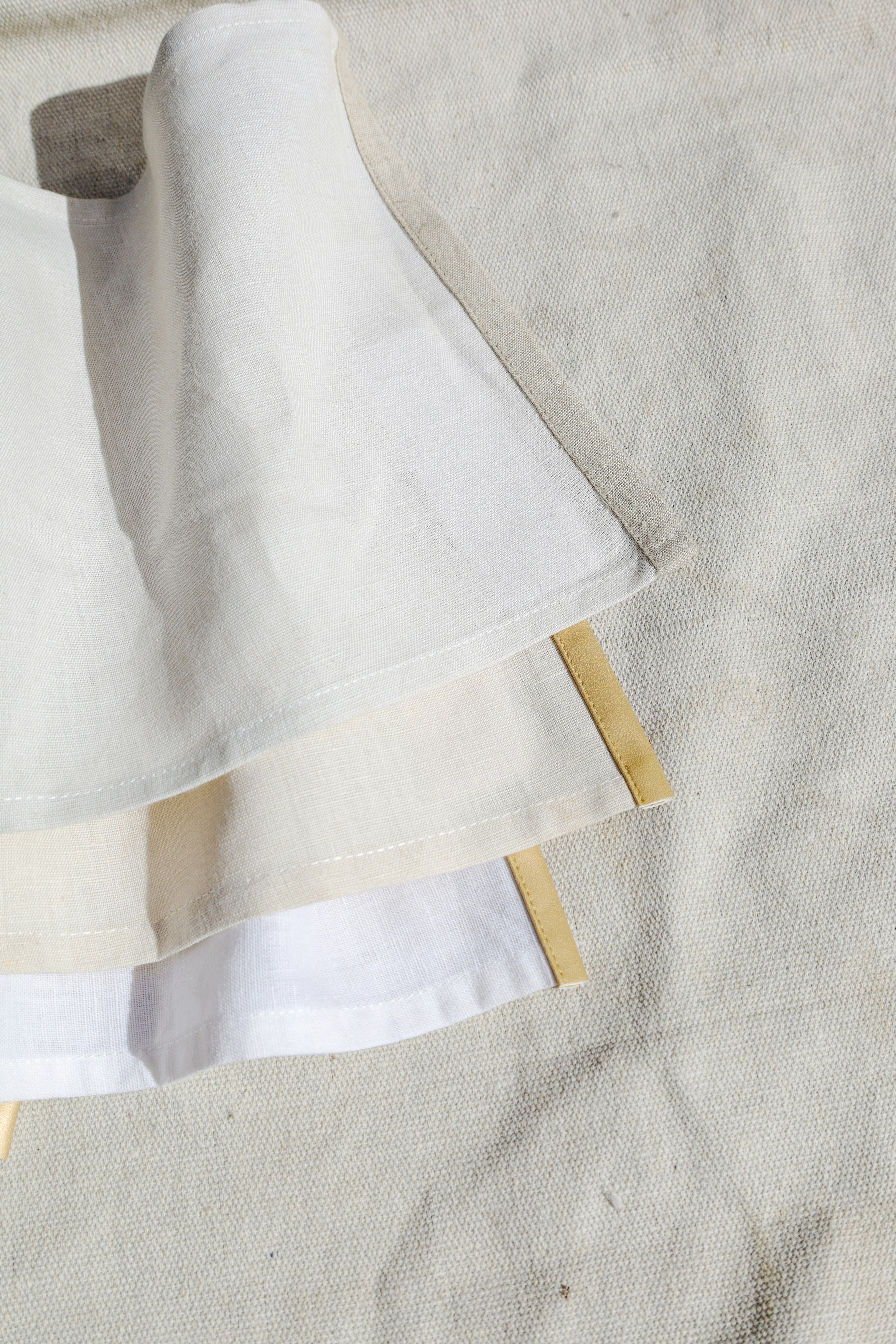 Folded linen napkins with subtle ribbon detail on the hem
