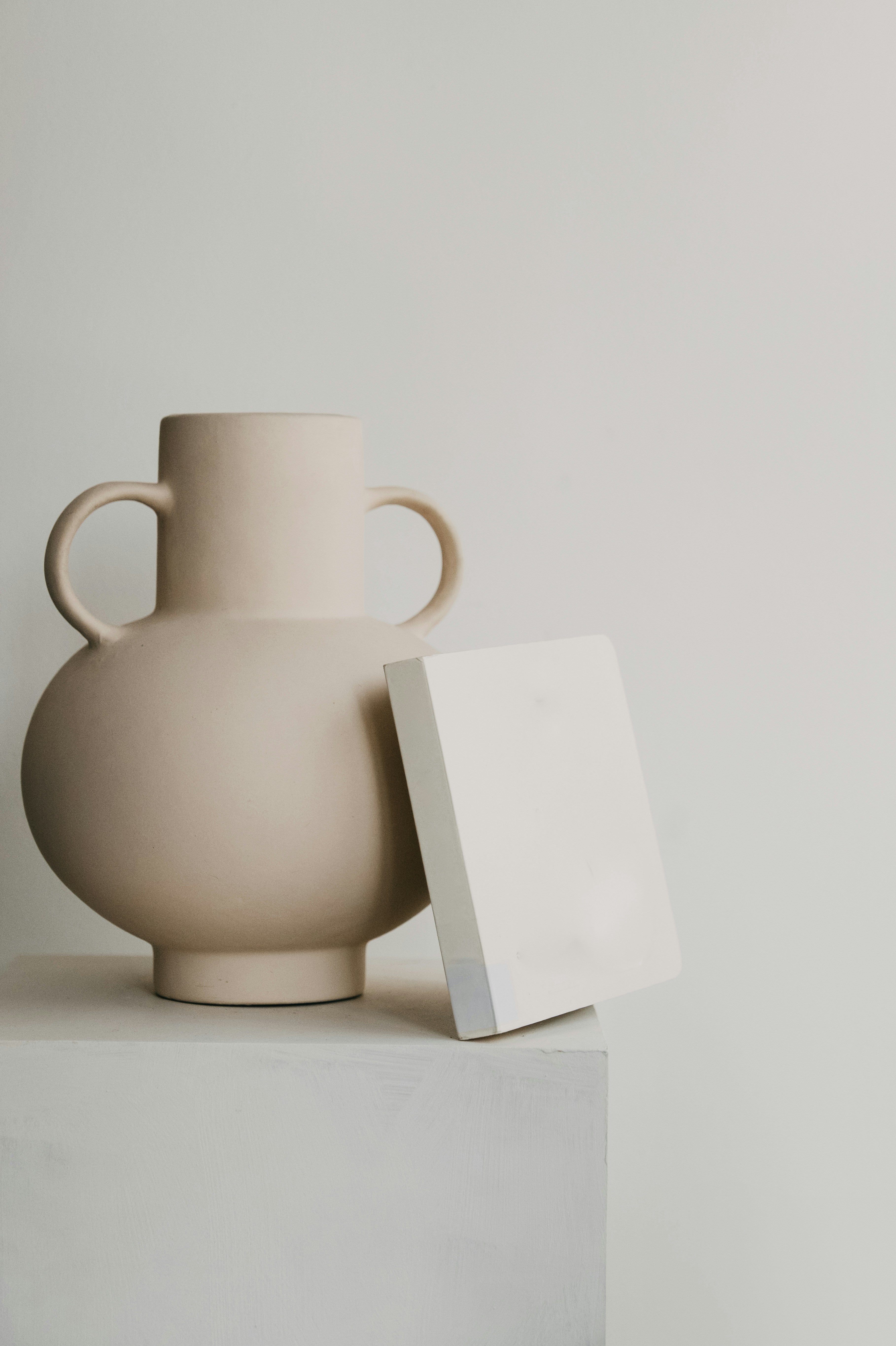 Two-handled cream stoneware amphora vase