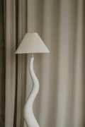 Pleated linen lampshade on sculptural ceramic base