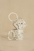 Pair of cream stoneware mugs with black speckled glaze